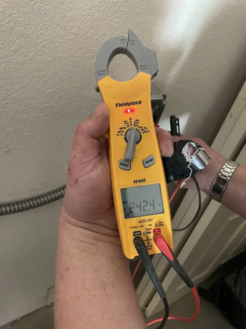 Voltage testing with clamp meter during Electrical Installation Services in Seven Oaks